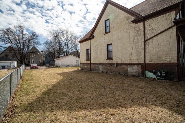 2214 N 40th St, Milwaukee, WI 53208 - view of property exterior with brick siding, a shingled roof, fence, and a lawn