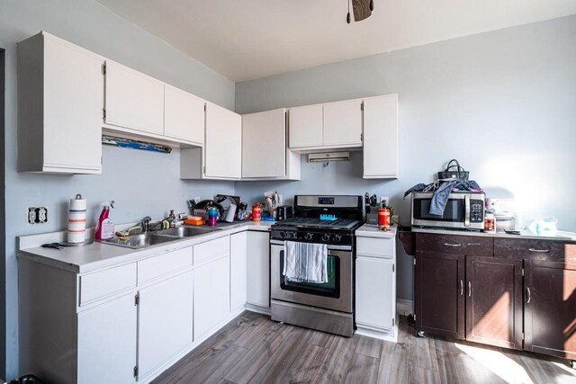 2214 N 40th St, Milwaukee, WI 53208 - kitchen with white cabinetry, light countertops, a sink, and appliances with stainless steel finishes
