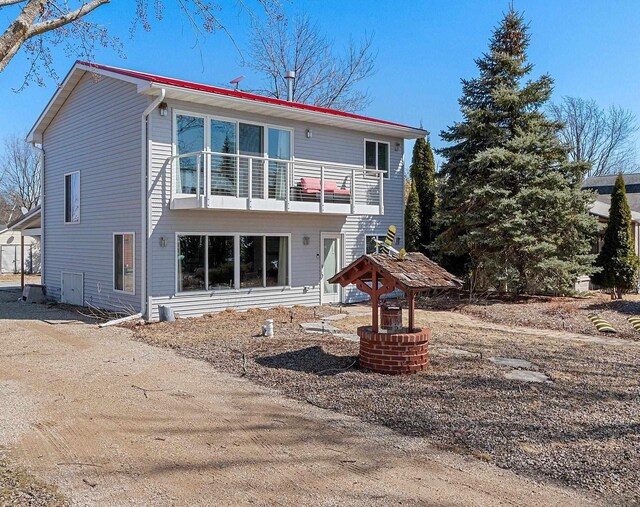 back of property featuring a balcony