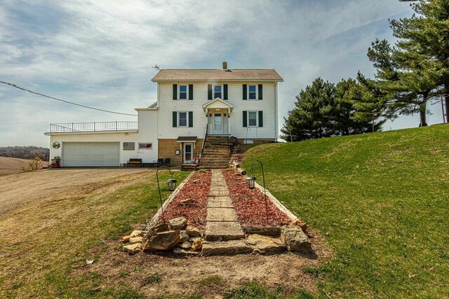 1943 State Road 11, South Wayne, WI 53587 - colonial home with driveway, a front yard, and a garage