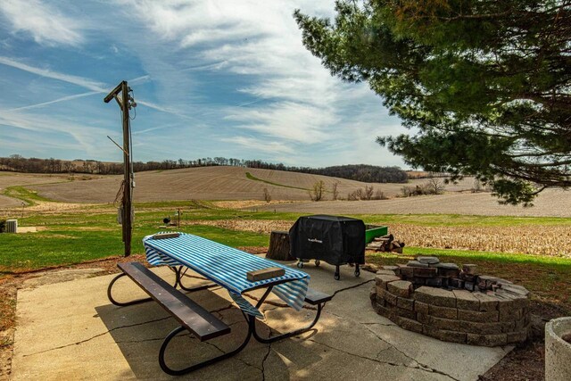 1943 State Road 11, South Wayne, WI 53587 - view of patio / terrace with a rural view and an outdoor fire pit