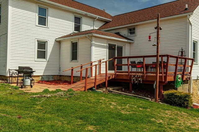 1943 State Road 11, South Wayne, WI 53587 - rear view of house featuring a lawn, a shingled roof, and a deck