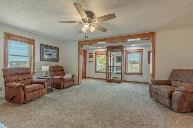 1943 State Road 11, South Wayne, WI 53587 - carpeted living room featuring a wealth of natural light, a ceiling fan, and baseboards