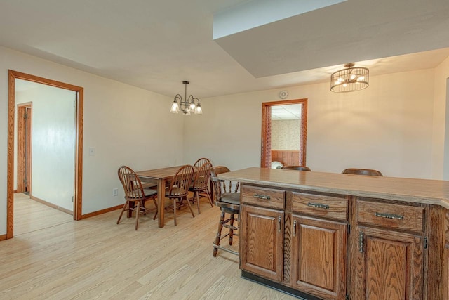 1943 State Road 11, South Wayne, WI 53587 - dining room featuring light wood-style floors, baseboards, and a notable chandelier