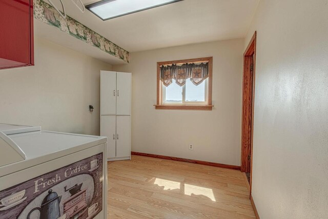 1943 State Road 11, South Wayne, WI 53587 - washroom featuring washing machine and dryer, light wood-style flooring, baseboards, and cabinet space