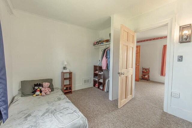 1943 State Road 11, South Wayne, WI 53587 - bedroom featuring a closet, visible vents, ornamental molding, and light carpet