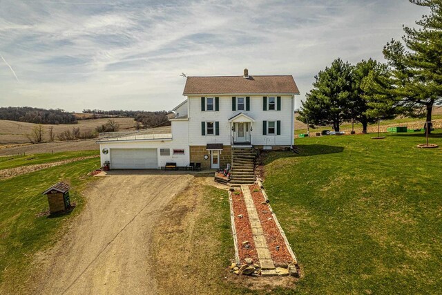 1943 State Road 11, South Wayne, WI 53587 - view of front facade featuring an attached garage, dirt driveway, and a front yard
