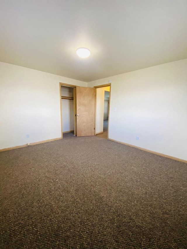 unfurnished room featuring baseboards and light colored carpet