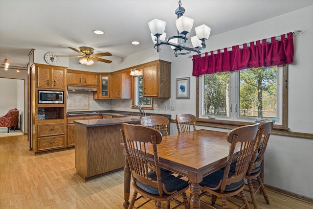 2925 Meadow Ln, Hartland, WI 53029 - dining room with baseboards, light wood-type flooring, recessed lighting, and ceiling fan with notable chandelier