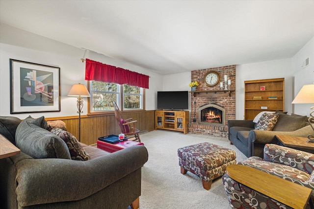 2925 Meadow Ln, Hartland, WI 53029 - living room featuring carpet, visible vents, a wainscoted wall, a brick fireplace, and wooden walls