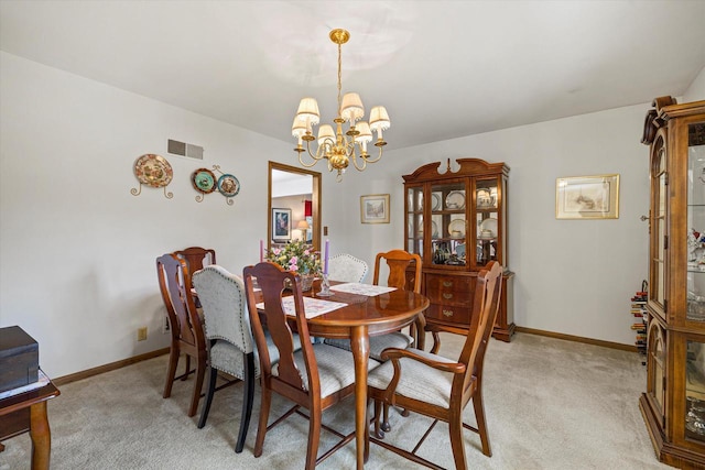 2925 Meadow Ln, Hartland, WI 53029 - dining space featuring visible vents, a notable chandelier, light colored carpet, and baseboards