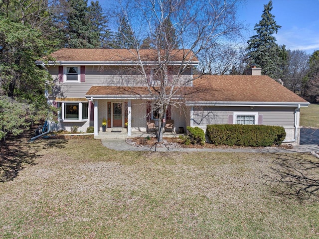 2925 Meadow Ln, Hartland, WI 53029 - view of front facade with a front yard, a chimney, and covered porch