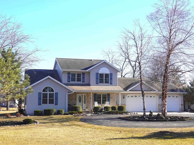 N8891 Gladstone Beach Rd, Fond Du Lac, WI 54937 - traditional-style house with a front yard, a shingled roof, an attached garage, driveway, and a porch