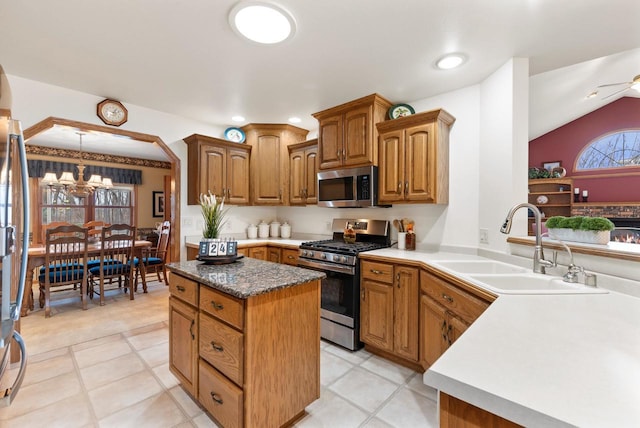 N8891 Gladstone Beach Rd, Fond Du Lac, WI 54937 - kitchen featuring appliances with stainless steel finishes, a center island, vaulted ceiling, a sink, and a chandelier