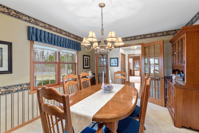 N8891 Gladstone Beach Rd, Fond Du Lac, WI 54937 - dining area with an inviting chandelier, french doors, and light colored carpet