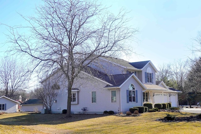 N8891 Gladstone Beach Rd, Fond Du Lac, WI 54937 - view of property exterior with a lawn and an attached garage