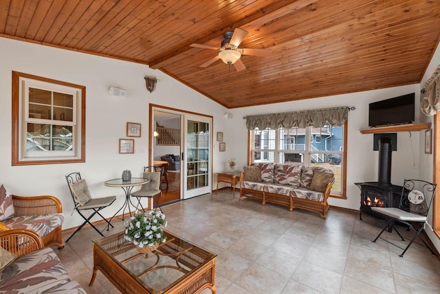 N8891 Gladstone Beach Rd, Fond Du Lac, WI 54937 - tiled living room with a wood stove, baseboards, ceiling fan, wood ceiling, and lofted ceiling with beams