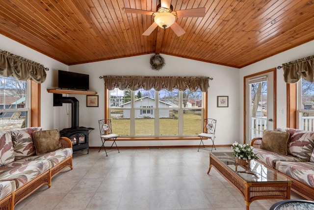 N8891 Gladstone Beach Rd, Fond Du Lac, WI 54937 - living room with baseboards, vaulted ceiling, ceiling fan, and a wood stove