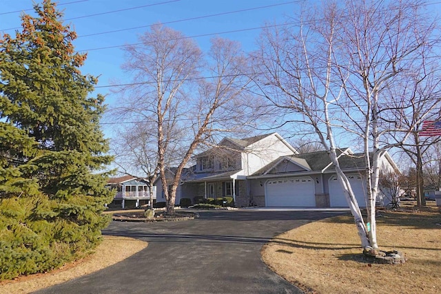 N8891 Gladstone Beach Rd, Fond Du Lac, WI 54937 - traditional-style house featuring an attached garage and aphalt driveway