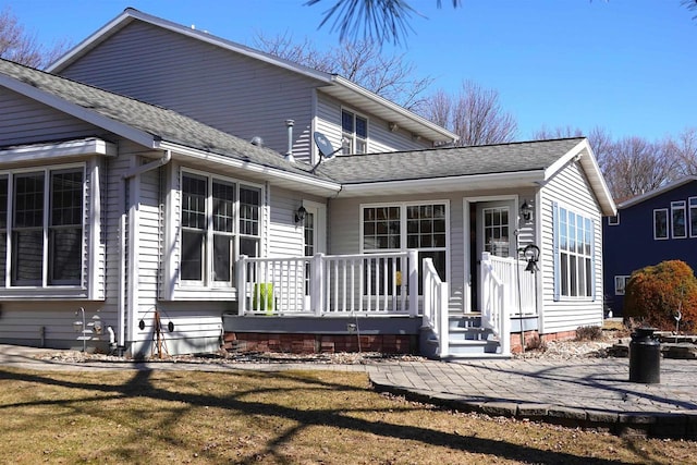 N8891 Gladstone Beach Rd, Fond Du Lac, WI 54937 - back of property with a patio, a shingled roof, and a yard