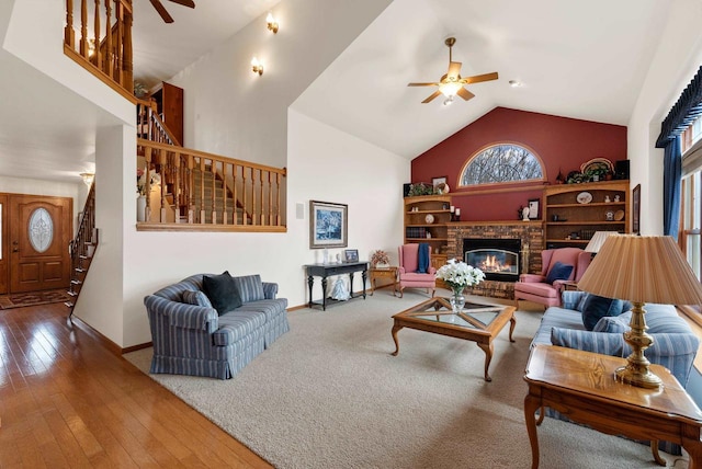 N8891 Gladstone Beach Rd, Fond Du Lac, WI 54937 - living area featuring a fireplace, high vaulted ceiling, a ceiling fan, baseboards, and stairway