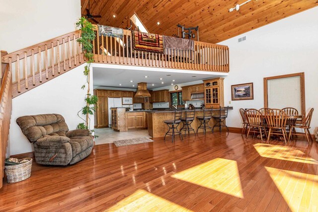 957 Whispering Ln, Hazel Green, WI 53811 - living room with stairway, wooden ceiling, baseboards, a towering ceiling, and light wood-style floors