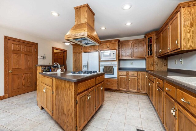 957 Whispering Ln, Hazel Green, WI 53811 - kitchen featuring island exhaust hood, white appliances, brown cabinets, dark countertops, and a sink