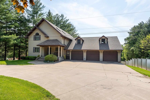 957 Whispering Ln, Hazel Green, WI 53811 - view of front of home with concrete driveway, fence, an attached garage, a front yard, and a shingled roof