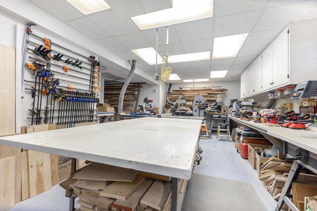 957 Whispering Ln, Hazel Green, WI 53811 - misc room featuring concrete floors, a paneled ceiling, and a workshop area