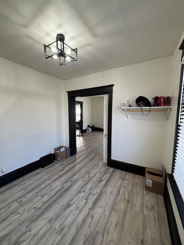 unfurnished dining area featuring baseboards and wood finished floors