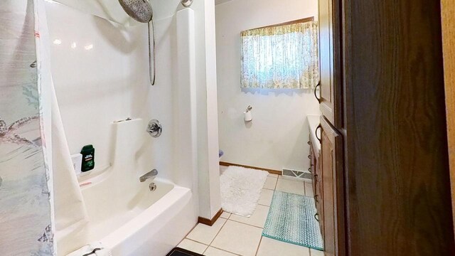 233 Highland St, Belmont, WI 53510 - bathroom with baseboards, visible vents, tile patterned flooring, and washtub / shower combination