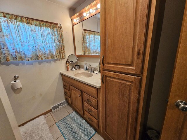 233 Highland St, Belmont, WI 53510 - bathroom with baseboards, visible vents, tile patterned floors, and vanity