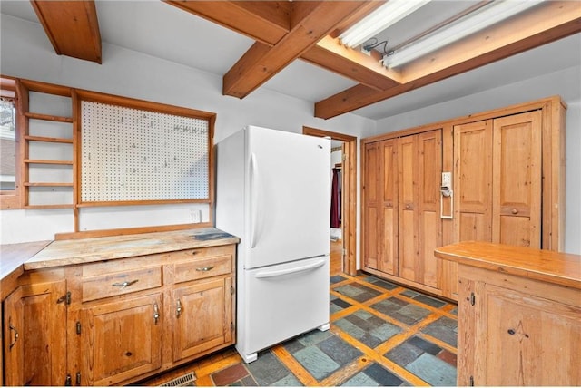8375 N Bass Lake Rd, Danbury, WI 54830 - kitchen with beamed ceiling, light countertops, open shelves, and freestanding refrigerator