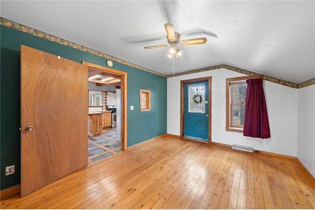 8375 N Bass Lake Rd, Danbury, WI 54830 - interior space featuring vaulted ceiling, visible vents, a ceiling fan, and wood-type flooring