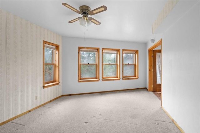 8375 N Bass Lake Rd, Danbury, WI 54830 - spare room featuring baseboards, a ceiling fan, wallpapered walls, and carpet