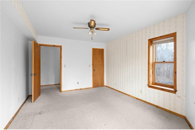 8375 N Bass Lake Rd, Danbury, WI 54830 - unfurnished bedroom with baseboards, wallpapered walls, ceiling fan, and carpet flooring
