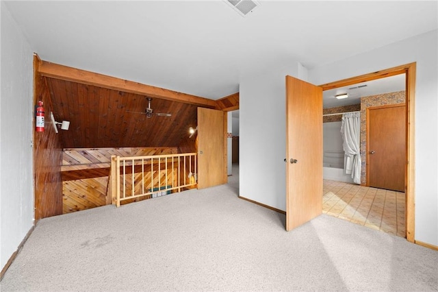 8375 N Bass Lake Rd, Danbury, WI 54830 - additional living space with carpet flooring, visible vents, wooden walls, a ceiling fan, and vaulted ceiling