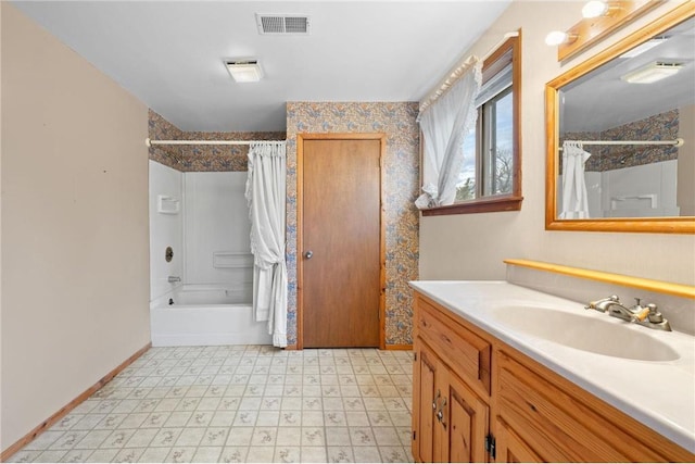 8375 N Bass Lake Rd, Danbury, WI 54830 - full bath with tile patterned floors, vanity, shower / bathtub combination with curtain, baseboards, and visible vents