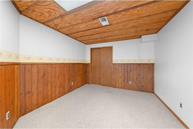 8375 N Bass Lake Rd, Danbury, WI 54830 - unfurnished room featuring a wainscoted wall, wood ceiling, carpet, and wooden walls