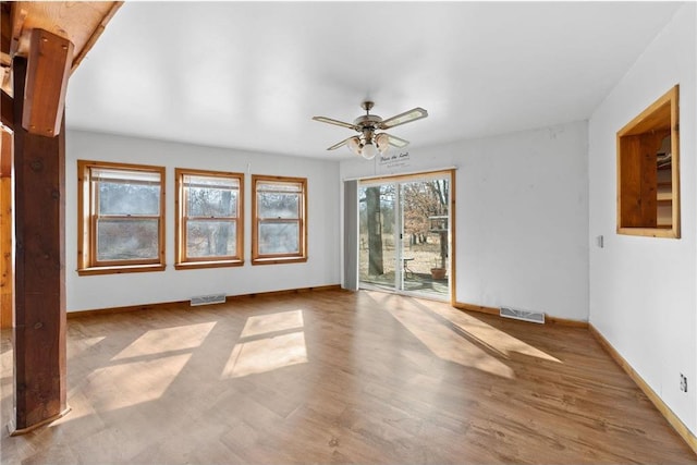 8375 N Bass Lake Rd, Danbury, WI 54830 - spare room with baseboards, visible vents, a ceiling fan, and wood finished floors