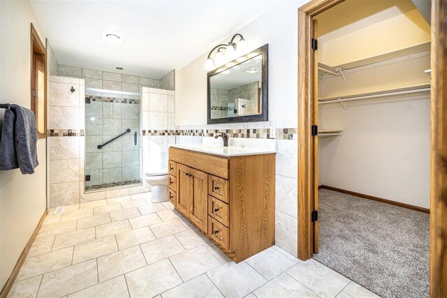 836 Westwind Dr, Black River Falls, WI 54615 - full bathroom featuring tile patterned floors, a stall shower, a spacious closet, vanity, and toilet