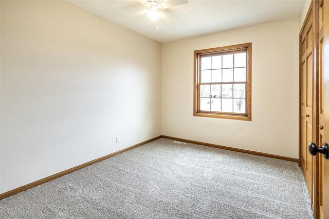 836 Westwind Dr, Black River Falls, WI 54615 - unfurnished bedroom featuring carpet floors, visible vents, baseboards, and ceiling fan