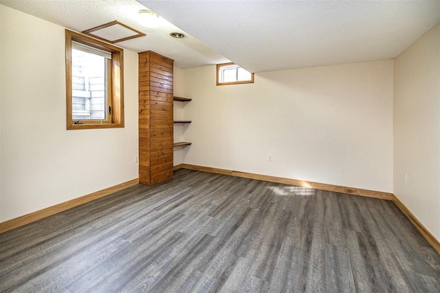 836 Westwind Dr, Black River Falls, WI 54615 - below grade area with baseboards, wood finished floors, and a textured ceiling