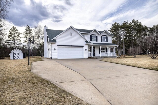 836 Westwind Dr, Black River Falls, WI 54615 - view of front of home featuring a front yard, a shed, concrete driveway, and covered porch