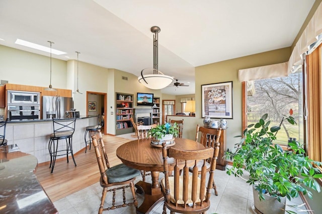 dining space with visible vents, high vaulted ceiling, and a ceiling fan