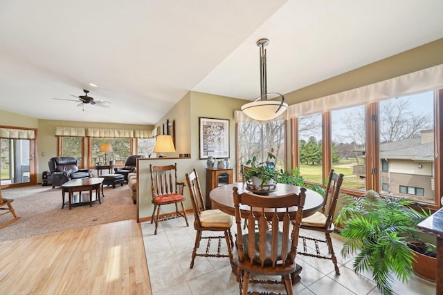 dining space with a ceiling fan, plenty of natural light, and baseboards