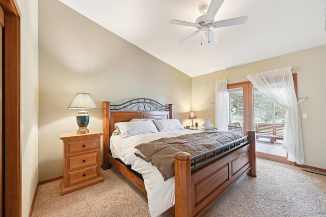 bedroom with light colored carpet, vaulted ceiling, baseboards, and access to outside