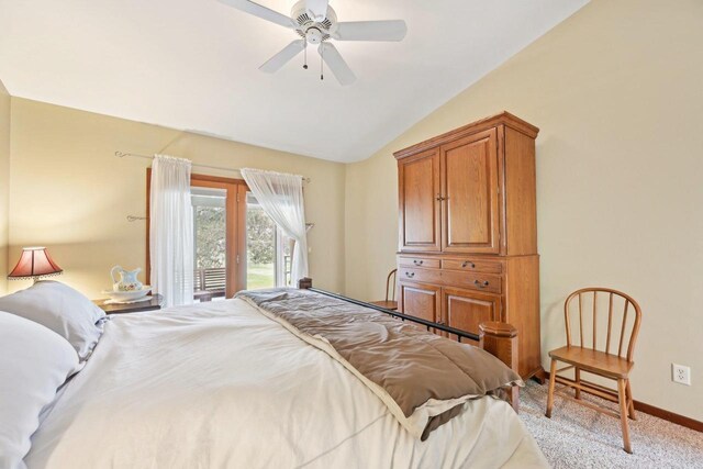bedroom featuring light carpet, baseboards, vaulted ceiling, and ceiling fan
