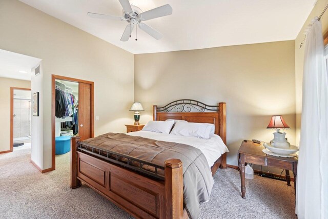 bedroom featuring a closet, visible vents, baseboards, a spacious closet, and light colored carpet