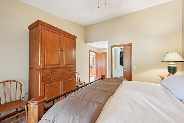 bedroom featuring a walk in closet, a closet, and ceiling fan